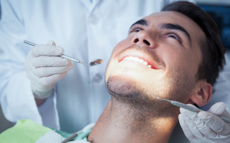 A man getting his teeth checked.